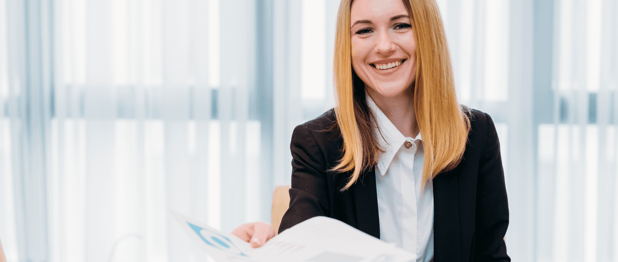 smiling woman at desk with resume