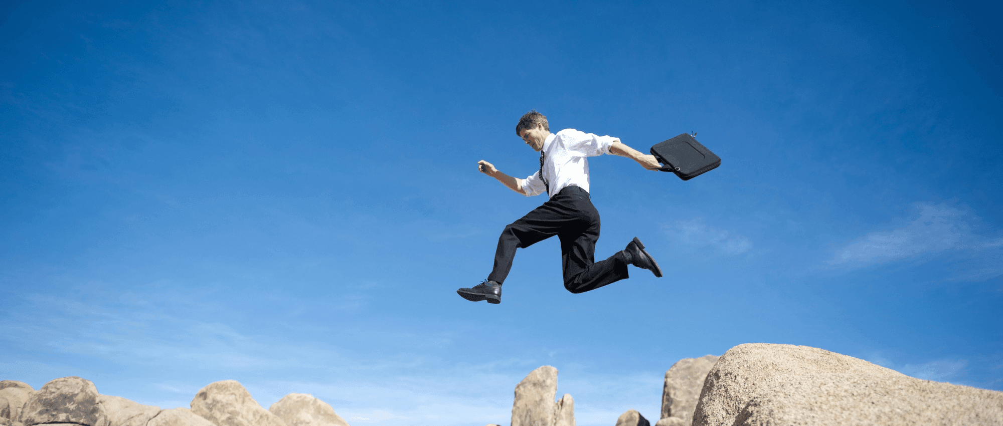 A man jumping from a cliff