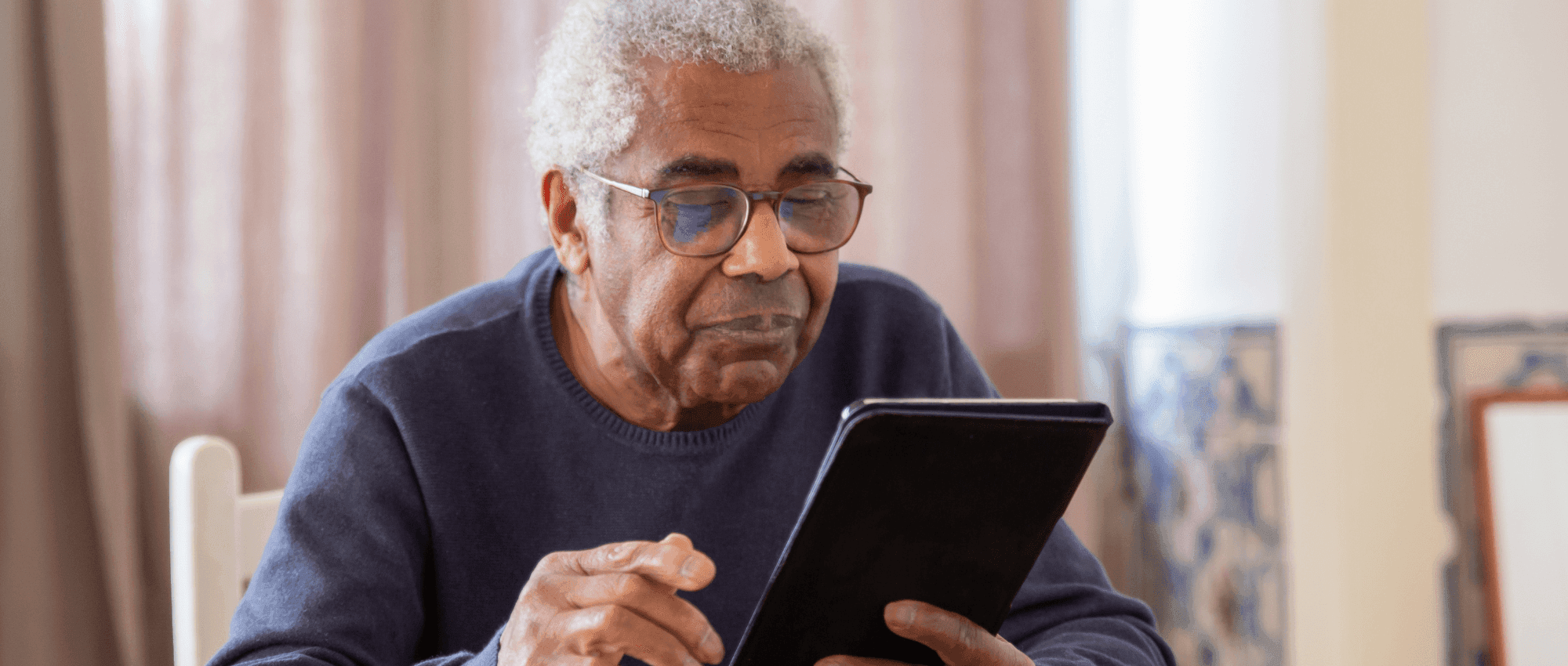 A senior holding an ipad