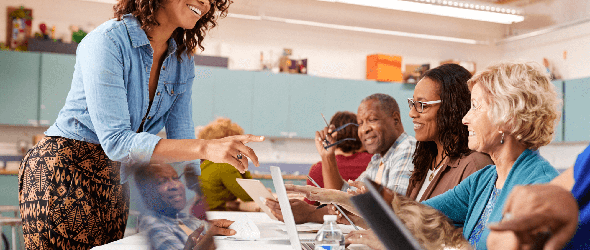 A person teaching seniors how to use technology