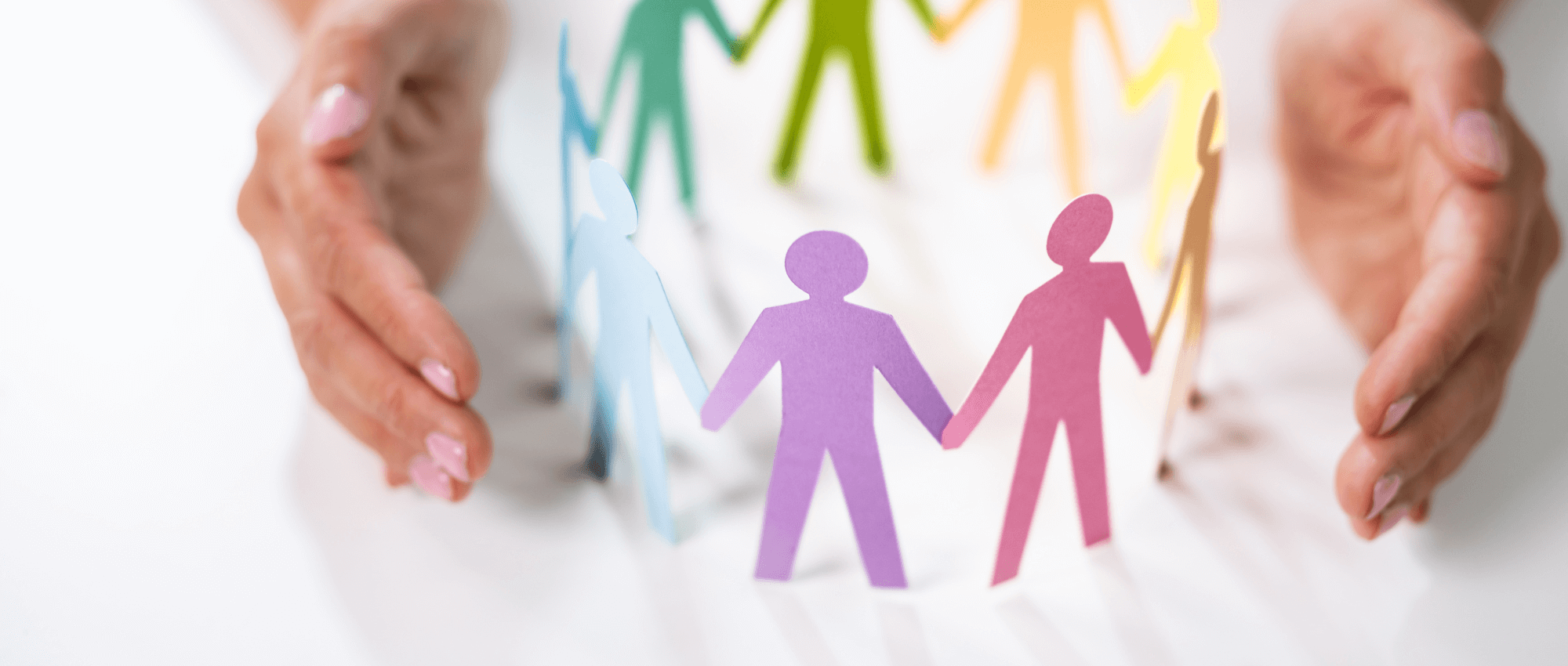 Colourful paper cut in the shape of human outline placed in a circle