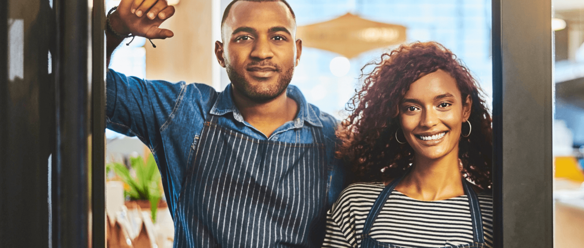 Two owners smiling to the camera